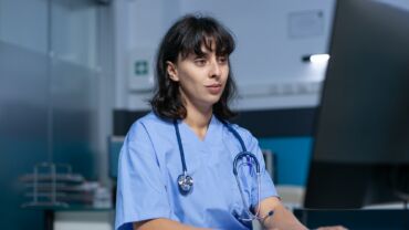 Healthcare specialist working with monitor and keyboard